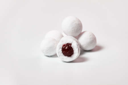Cranberries in powdered sugar on a white background.の写真素材