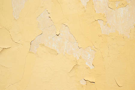 Old peeling whitewash on a scratched wall.の写真素材