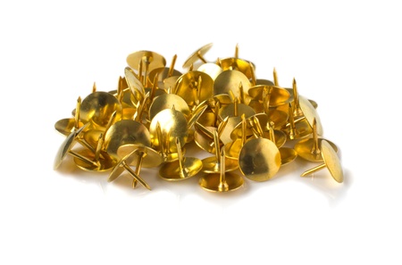 Brass drawing pins on a white backgroundの写真素材