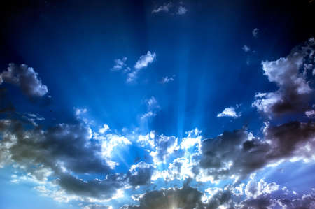 Sun rays behind clouds after a storm