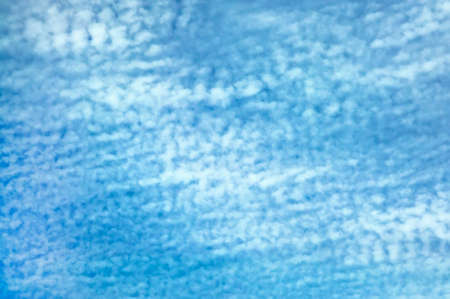 Blue sky background  with white fluffy cloudsの写真素材