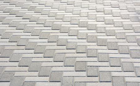 Fragment of old pavement of gray paving slabs.