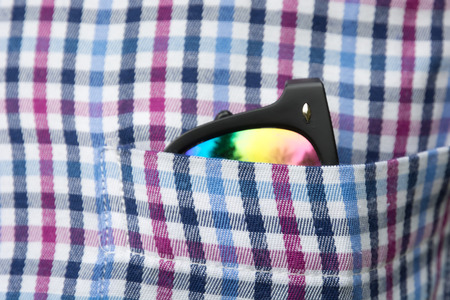 Sunglasses plaid shirt pocket close up. Soft focus.の写真素材