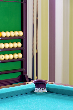 Corner of the pool table in the interior of the billiard room. Close-up