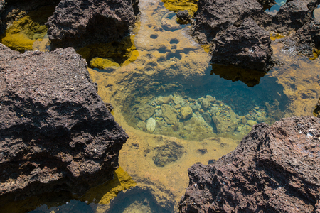 stone pit on the coast filled with sea waterの写真素材