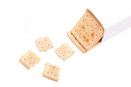 a packet of biscuits and one broken isolated on white backgroundの写真素材