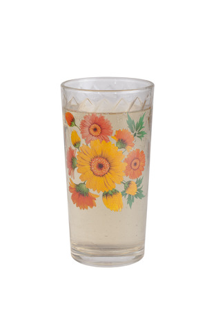 Sparkling water in a glass with floral pattern isolated on a white backgroundの写真素材