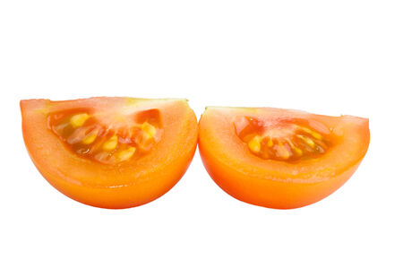 two slices yellow tomatoes isolated on white backgroundの写真素材