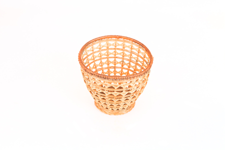 wicker basket for fruits isolated on white backgroundの写真素材
