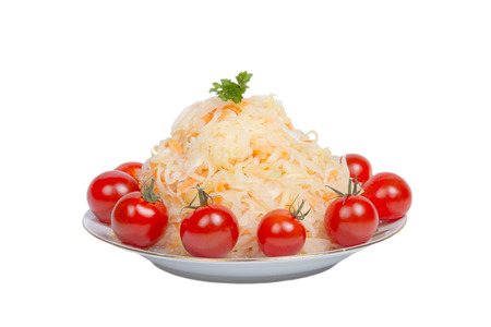 Sauerkraut with tomatoes on a plate isolated on white background. Shallow depth of fieldの写真素材