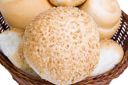 bread in a wicker basket isolated on white backgroundの写真素材