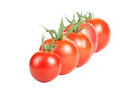 tomatoes constructed in a row isolated on white backgroundの写真素材