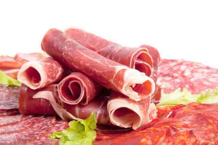 Plate with different meat delicacies isolated on white background. Shallow depth of fieldの写真素材