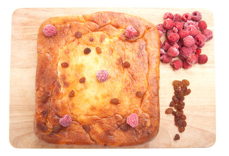 Cottage cheese casserole with raspberries, raisins on a white backgroundの写真素材