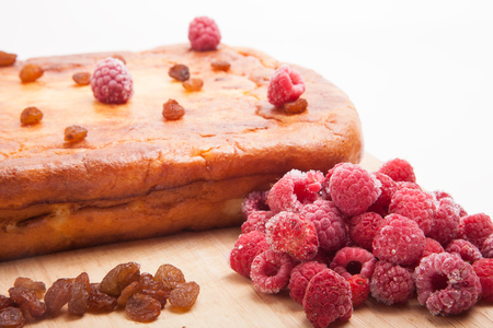 Cottage cheese casserole with raspberries, raisins on a white backgroundの写真素材