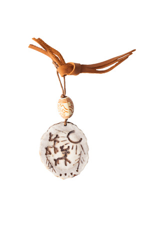 amulet of deer antlers on a leather strap, isolated on white backgroundの写真素材
