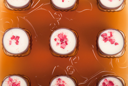 Chocolates with raspberries in a plastic blister pack front viewの写真素材