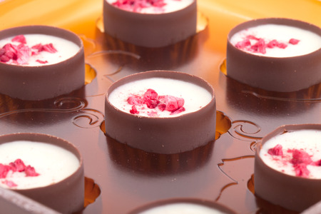 Chocolates with raspberries in a plastic blister packの写真素材