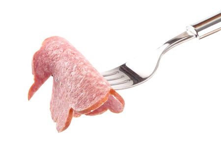 A piece of sausage on a fork isolated on white backgroundの写真素材