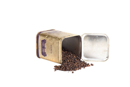 old aluminum cans with crumbled pepper isolated on white background