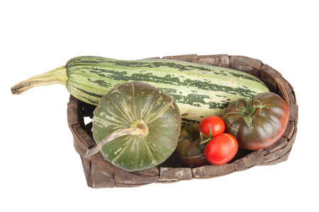 freshly harvested vegetables in the old basketの写真素材