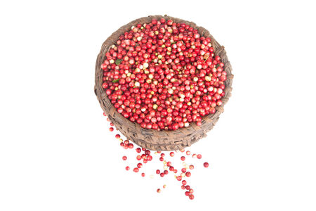 berries a cowberry in the old basket isolated on white backgroundの写真素材