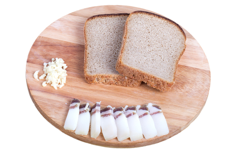 black bread, bacon, garlic on a board isolated on white background. Shallow depth of fieldの写真素材