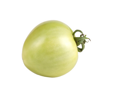 green unripe tomato isolated on white backgroundの写真素材