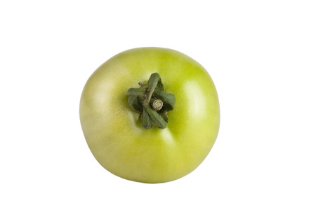 green unripe tomato isolated on white backgroundの写真素材
