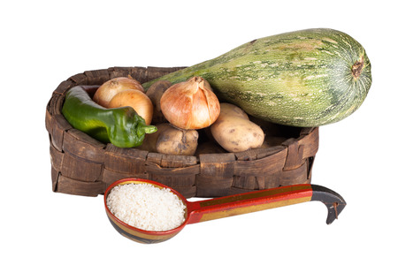 vegetables in the old basket and rice in an old ladle isolated on white backgroundの写真素材