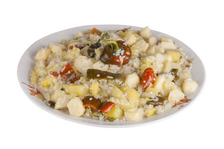 vegetable stew with sweet peppers and rice on a plate, isolated on white backgroundの写真素材