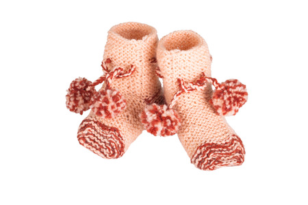 knitted baby shoes isolated on white backgroundの写真素材