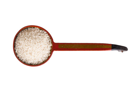 round Kuban rice in an old wooden ladle isolated on white backgroundの写真素材