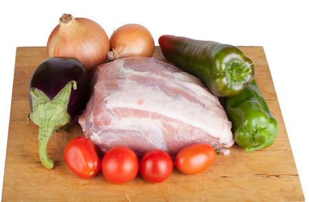 Vegetables with meat lying on a board isolated on white backgroundの写真素材
