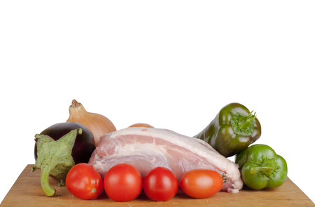 Vegetables with meat lying on a board isolated on white backgroundの写真素材