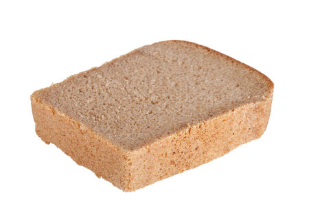 a piece of black bread isolated on white background with shallow depth of fieldの写真素材