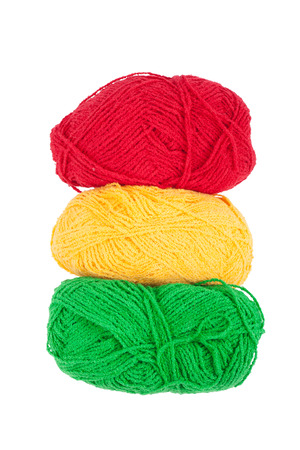 Green yellow red skeins of wool isolated on a white backgroundの写真素材