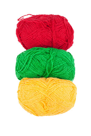 Green yellow red skeins of wool isolated on a white backgroundの写真素材