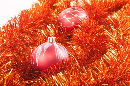 Red Christmas balls on the background of red tinselの写真素材