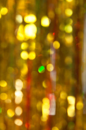 Abstract Christmas twinkled bright background with bokeh defocused yellow and green lights.Verticalの写真素材