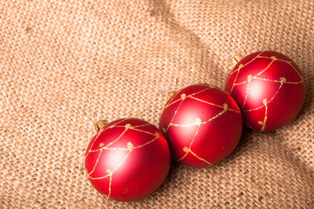 Three red Christmas tree ball on sackingの写真素材
