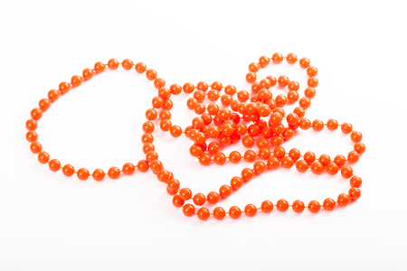 Orange necklace of balls on white backgroundの写真素材