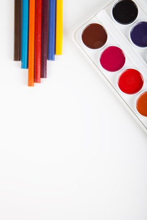 Watercolor box and pencils on light backgroundの写真素材