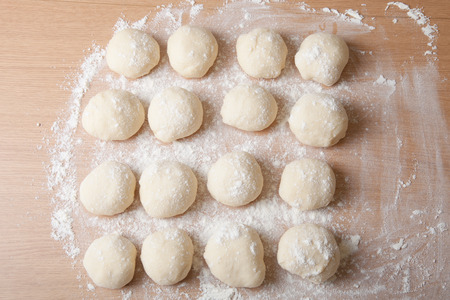 Small balls of dough with flour for pizza or cakes and scones. Shallow depth of fieldの写真素材