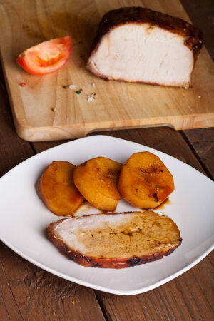 pork with potatoes on old wooden tableの写真素材