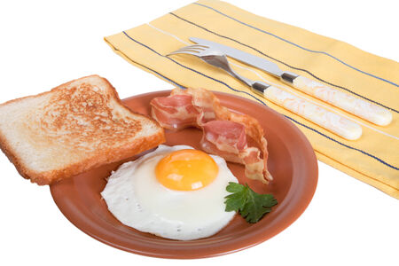 Fried eggs with bacon and bread isolated on white backgroundの写真素材