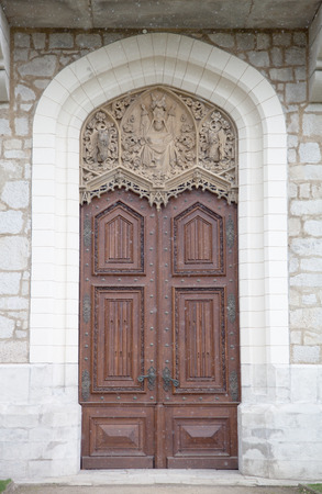 Old wooden door with ornaments in a knight's castle. with snowingの写真素材