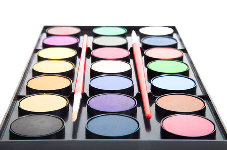 colorful watercolors paints in palette with brushes isolated on white backgroundの写真素材