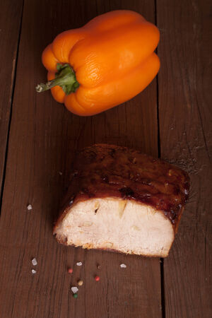 piece of pork and pepper on old wooden tableの写真素材