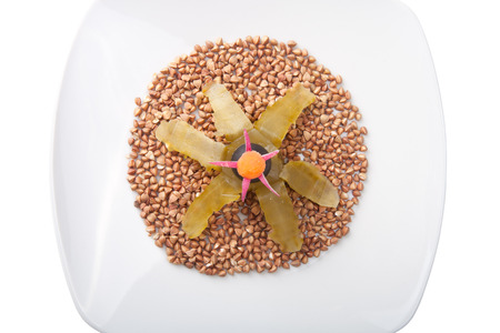 plate with buckwheat groats decorated isolated on white backgroundの写真素材